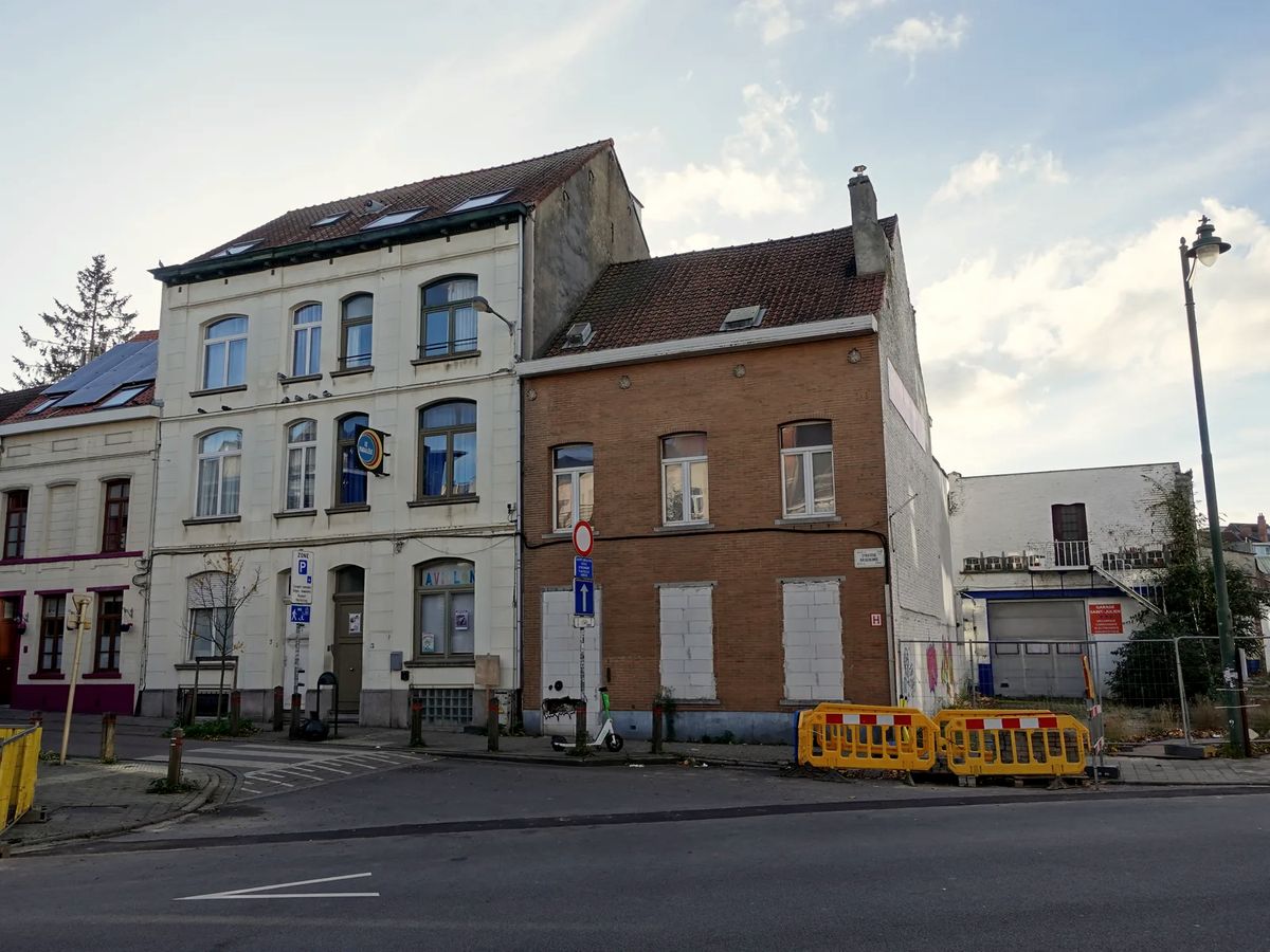 Maisons mitoyennes en brique et en façade blanche au coin d'une rue de Wavre